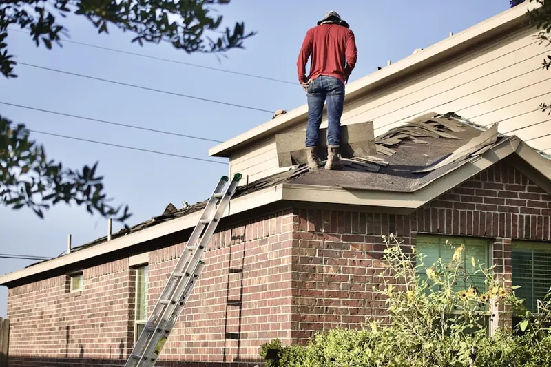 Professional roofer working on a residential roof in Ferndale